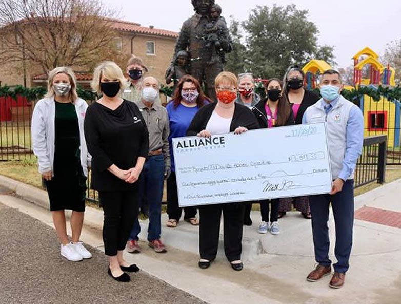 Presentation of an oversized check to the staff of the Lubbock Ronald McDonald House, a donation raised by ALLIANCE Credit Union Foundation.