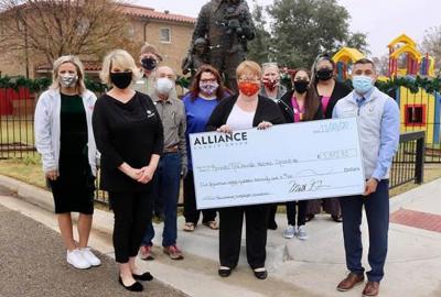 Presentation of an oversized check to the staff of the Lubbock Ronald McDonald House, a donation raised by ALLIANCE Credit Union Foundation.